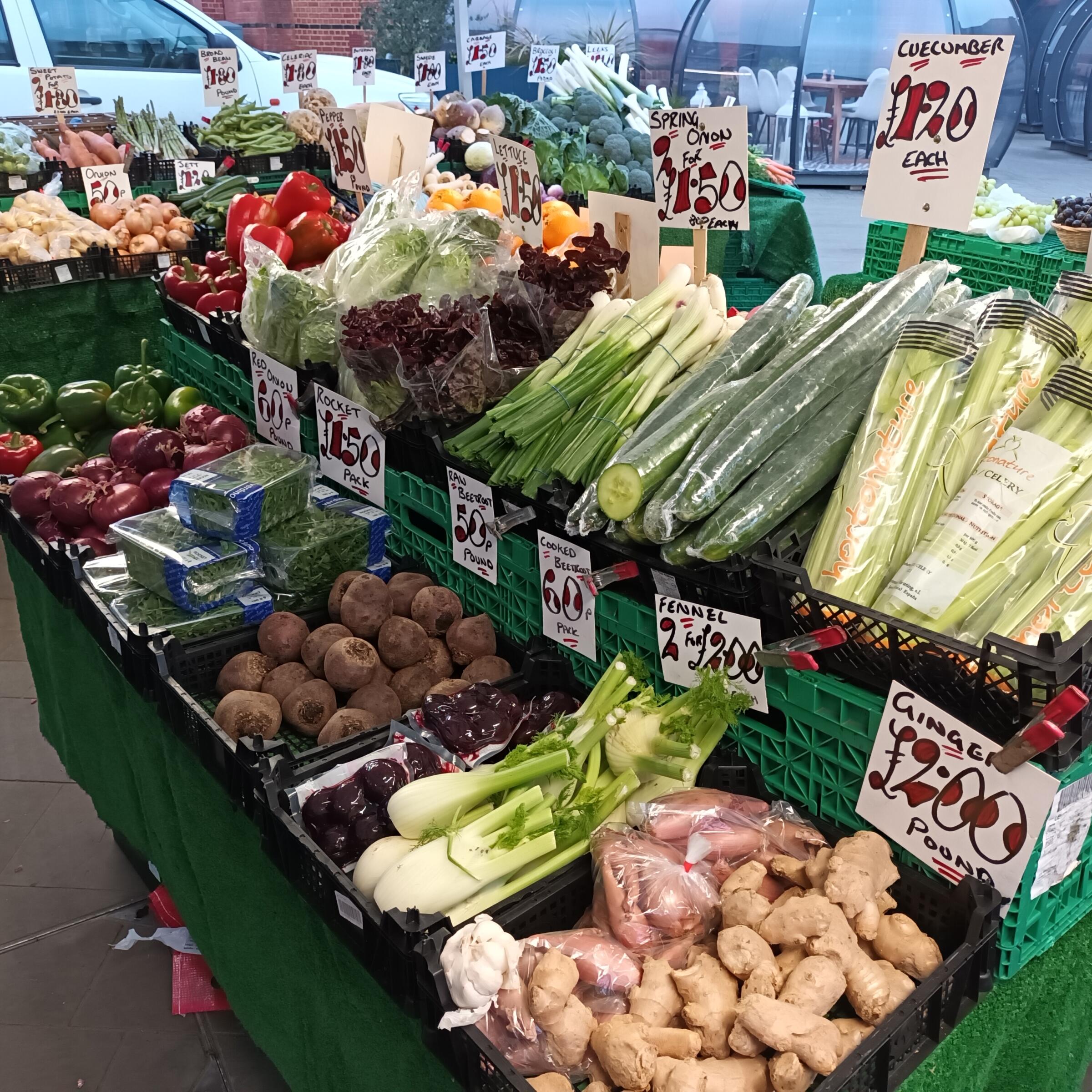 Shelves of fresh vegetables on a market stall