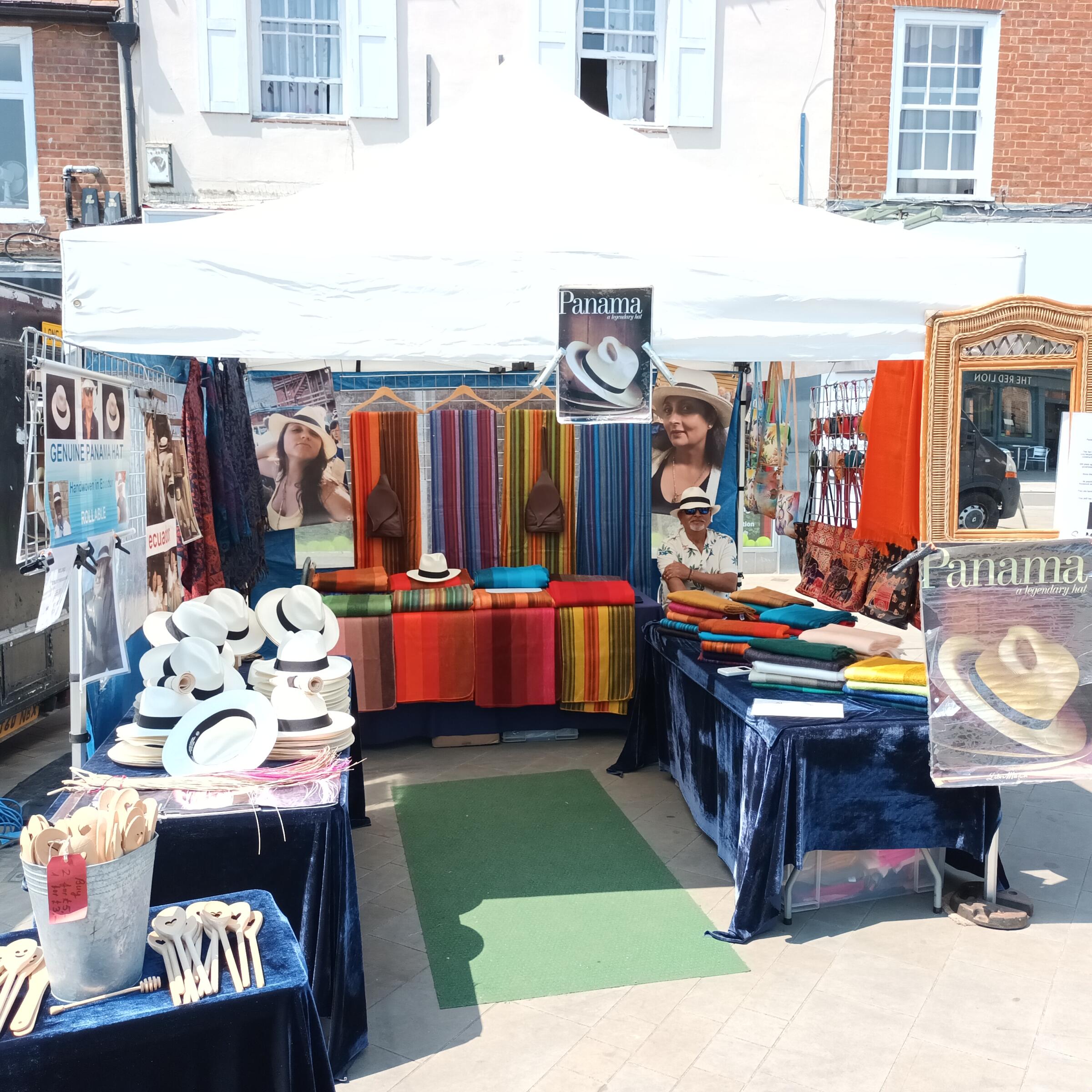 Trader on a stall with Panama hats and clothing