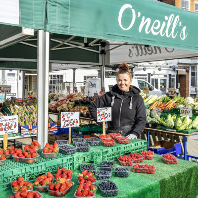 Trader with fresh fruit and vegetables