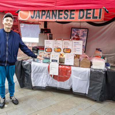 Trader in front of a Japanese hot food stall