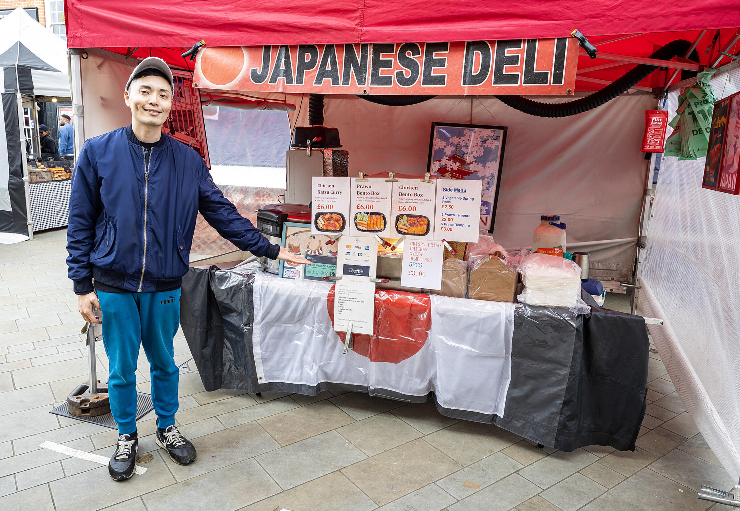 Trader in front of a Japanese hot food stall