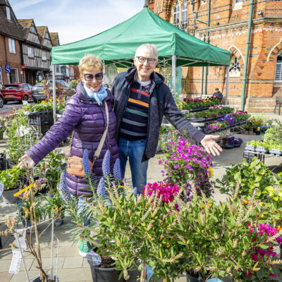 Two traders surrounded by potted plants